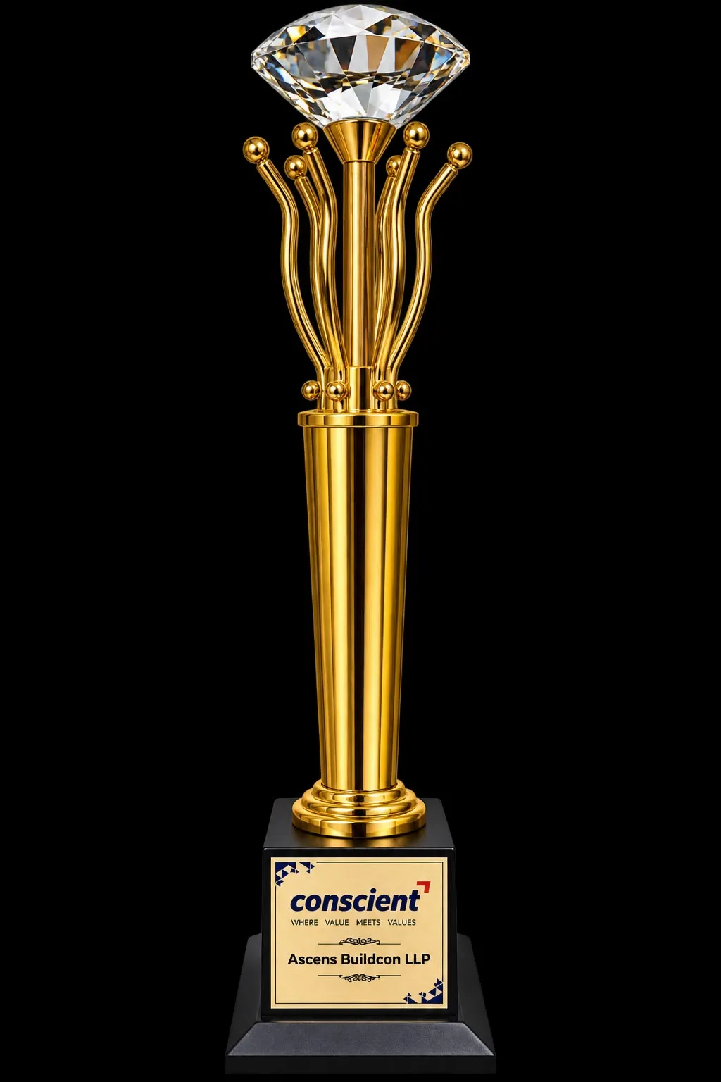 Tall gold trophy topped with a cut crystal, engraved by Conscient for Ascens Buildcon LLP.