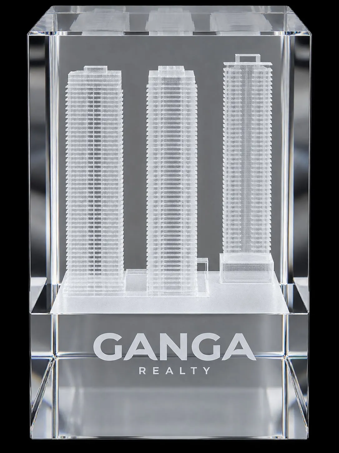 Clear crystal block award from Ganga Realty with three etched residential towers inside it.